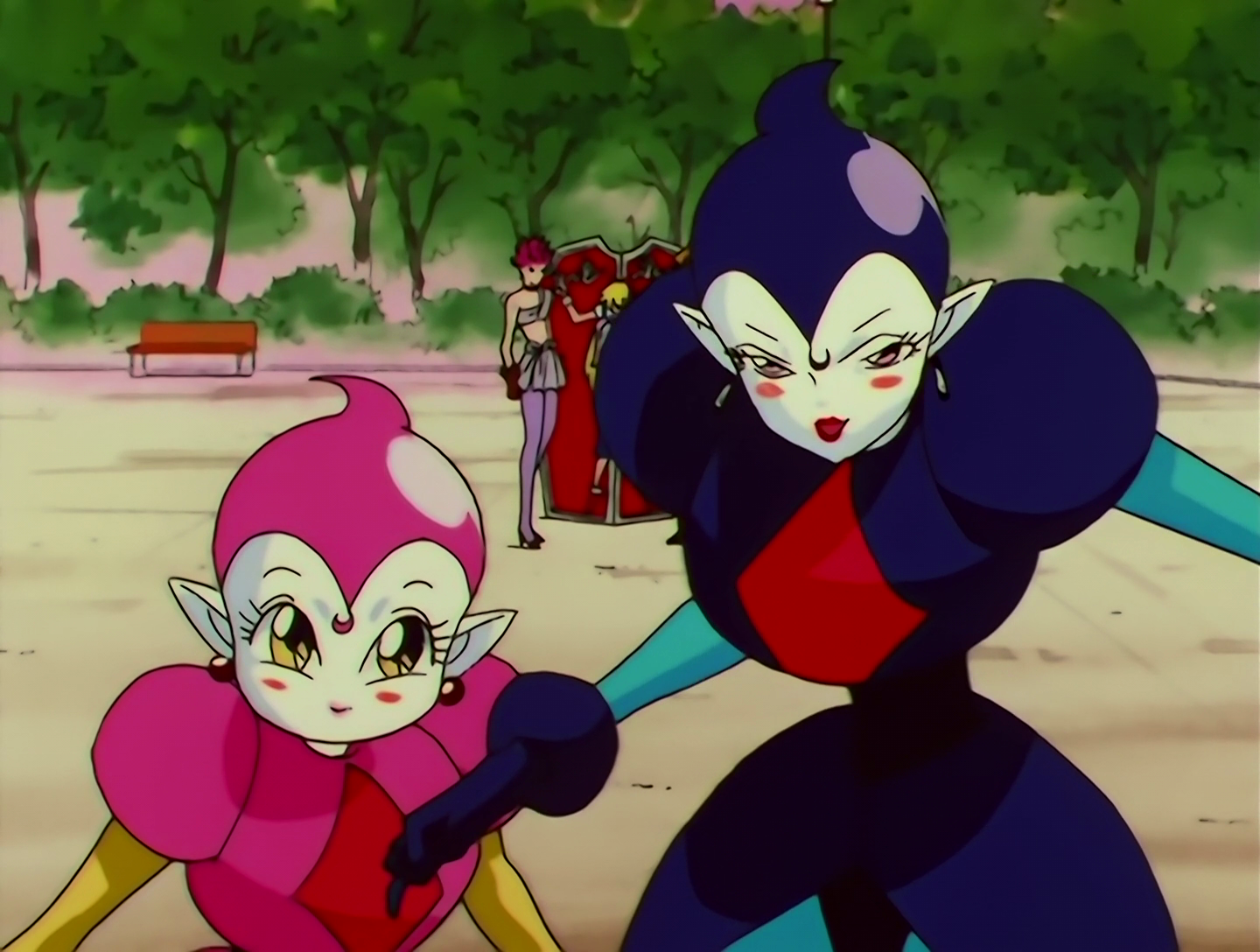 Bakkonko and Gittanko, Lemures from Sailor Moon episode 141. They have pale white skin, and they both wear shiny bodysuits with hoods and large shoulders. Bakkonko, on the left, is very short and her outfit is pink. Gittanko, on the right, is much taller and her outfit is black.